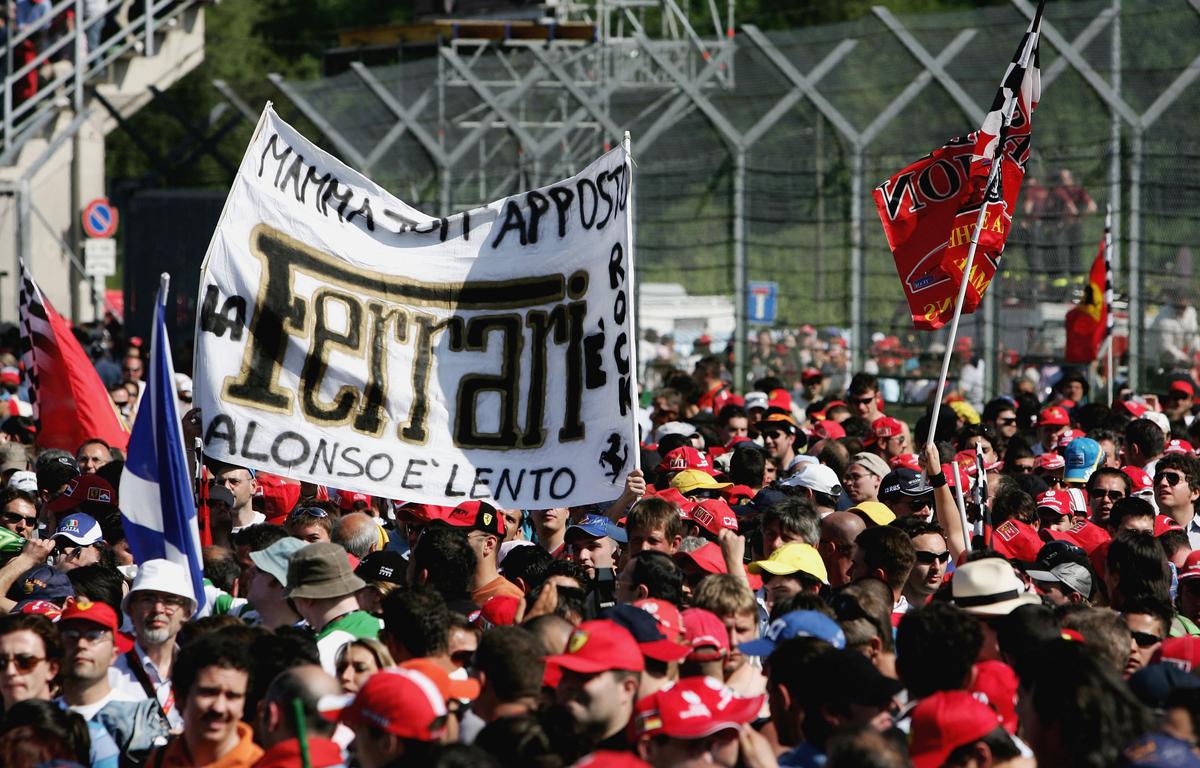 Ferrari fans celebrate after Michael Schumacher of Germany and Ferrari won the San Marino Formula One Grand Prix on April 23, 2006
