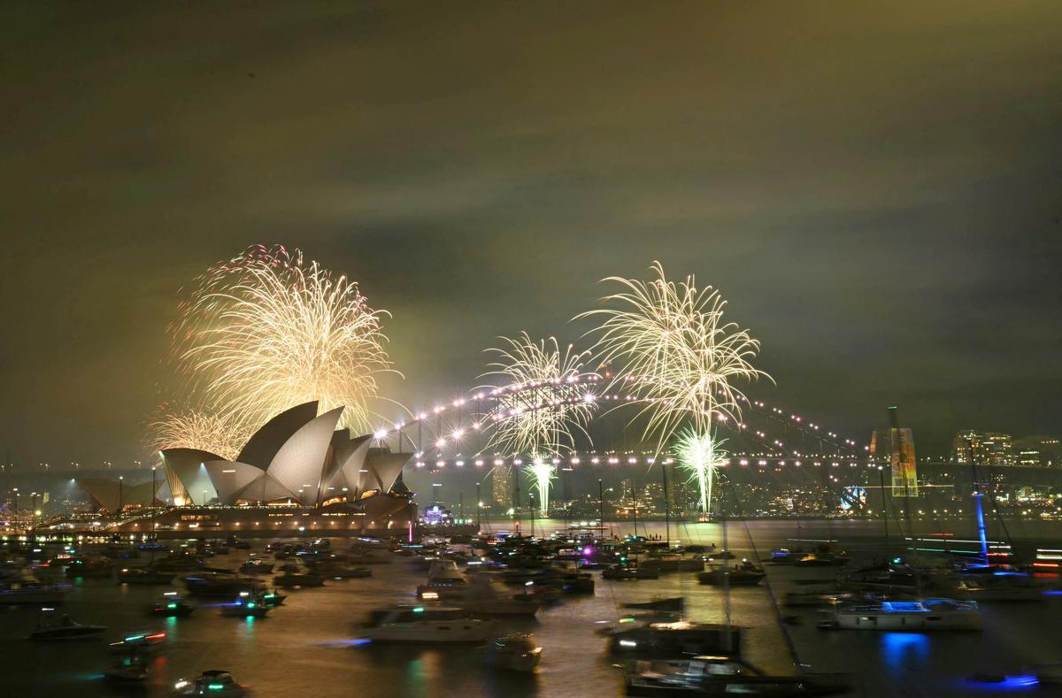 The “family fireworks” light up the Opera House and the Sydney Harbour Bridge, three hours ahead of the main show at midnight in Sydney on New Year’s Eve on December 31, 2024. 