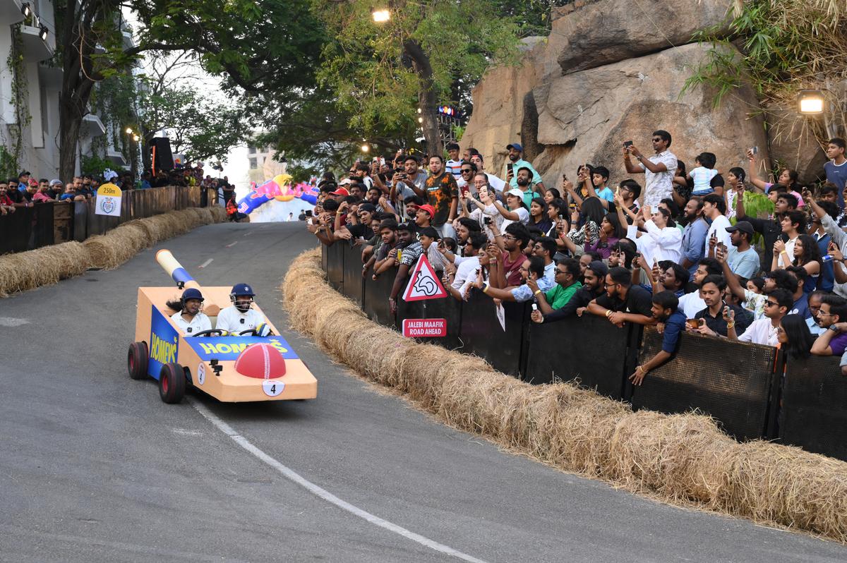A car races down the track at the Soapbox Race 2024