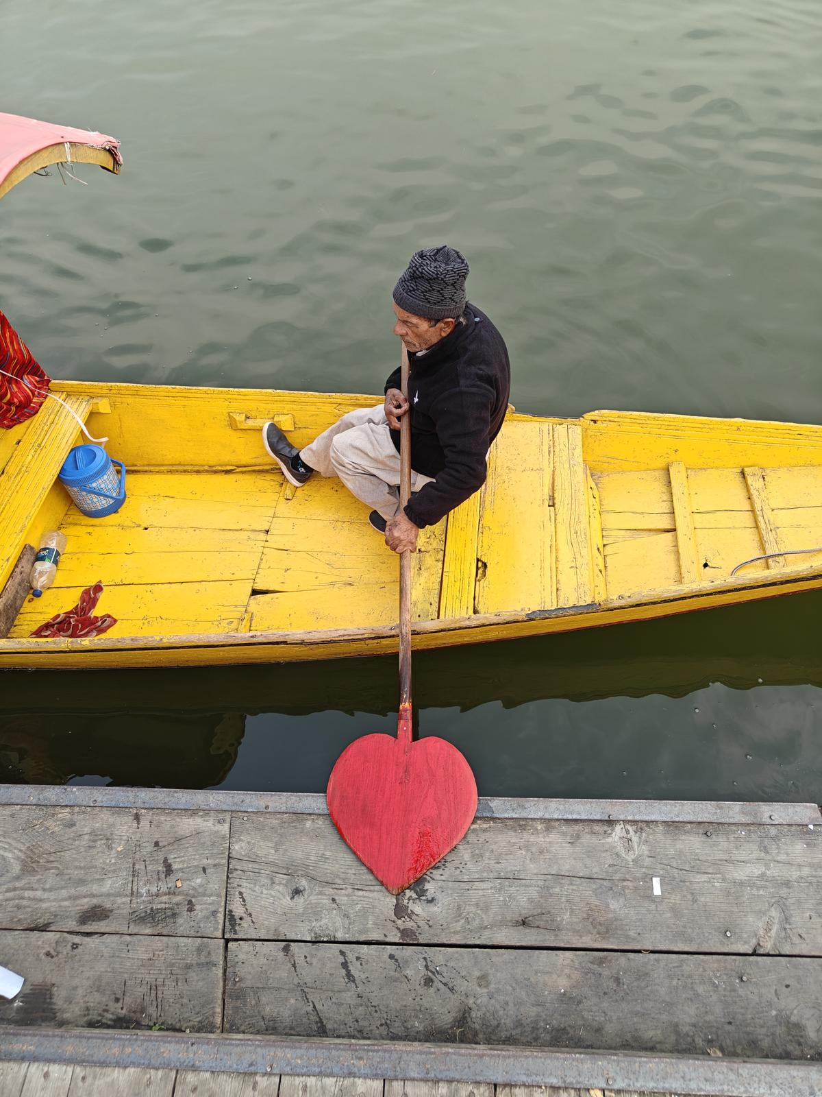 A shikhara owner pushes out of shore at the Dal Lake in Srinagar, Kashnir