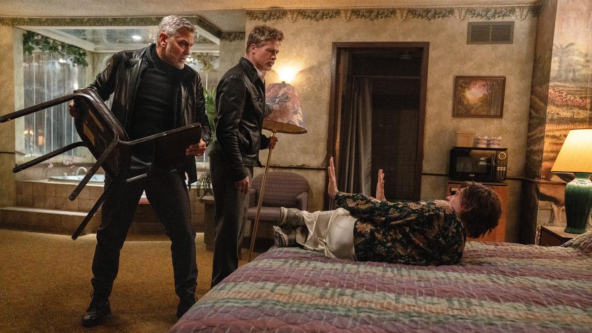 Brad Pitt, George Clooney and Austin Abrams in a still from ‘Wolfs’