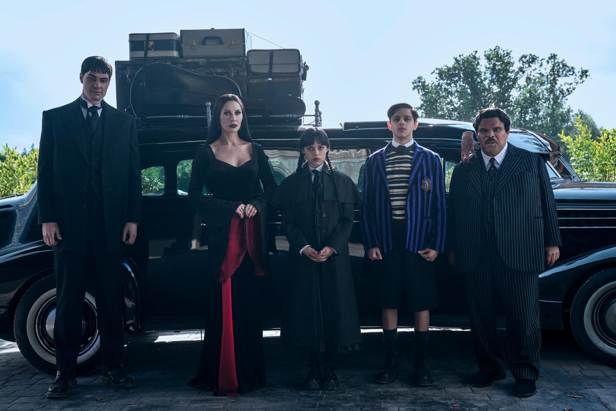(L to R) Joonas Suotamo as Lurch, Catherine Zeta-Jones as Morticia Addams, Jenna Ortega as Wednesday, Isaac Ordonez as Pugsley Addams, Thing, Luis Guzmán as Gomez Addams in ‘Wednesday’ Season 2 (L to R) Joonas Suotamo as Lurch, Catherine Zeta-Jones as Morticia Addams, Jenna Ortega as Wednesday, Isaac Ordonez as Pugsley Addams, Thing, Luis Guzmán as Gomez Addams in ‘Wednesday’ Season 2