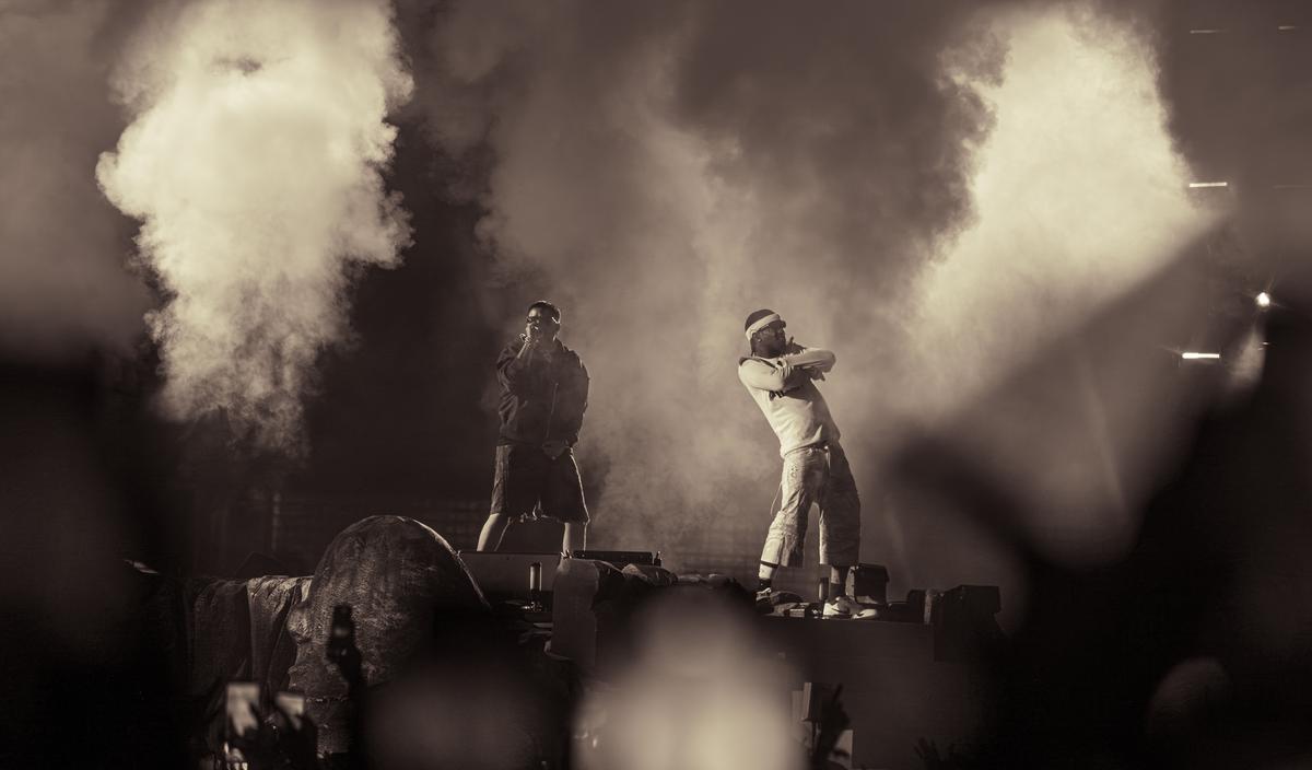 Punjabi Canadian rapper NAV and Travis Scott perform on stage during his Circus Maximus concert at Delhi’s Jawaharlal Nehru Stadium, on October 18, 2025