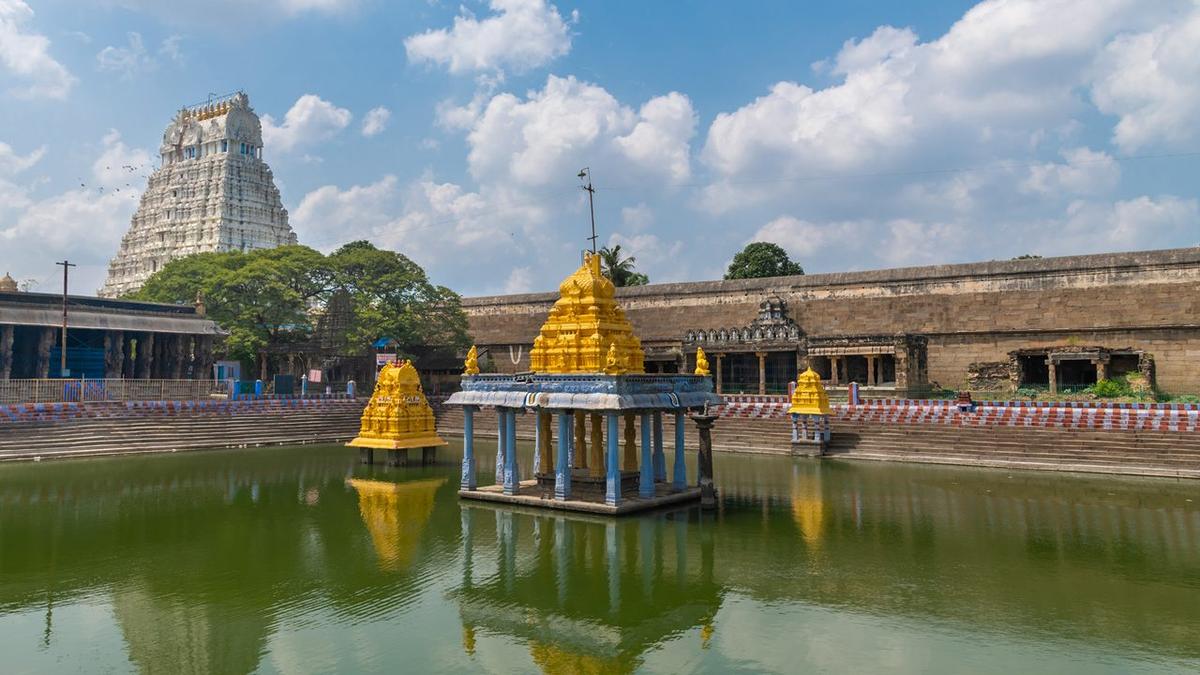 The temple tank inside Sri Varadaraja Perumal temple in Kanchipuram with the temple tower seen in the background. The temple tank inside Sri Varadaraja Perumal temple in Kanchipuram with the temple tower seen in the background.