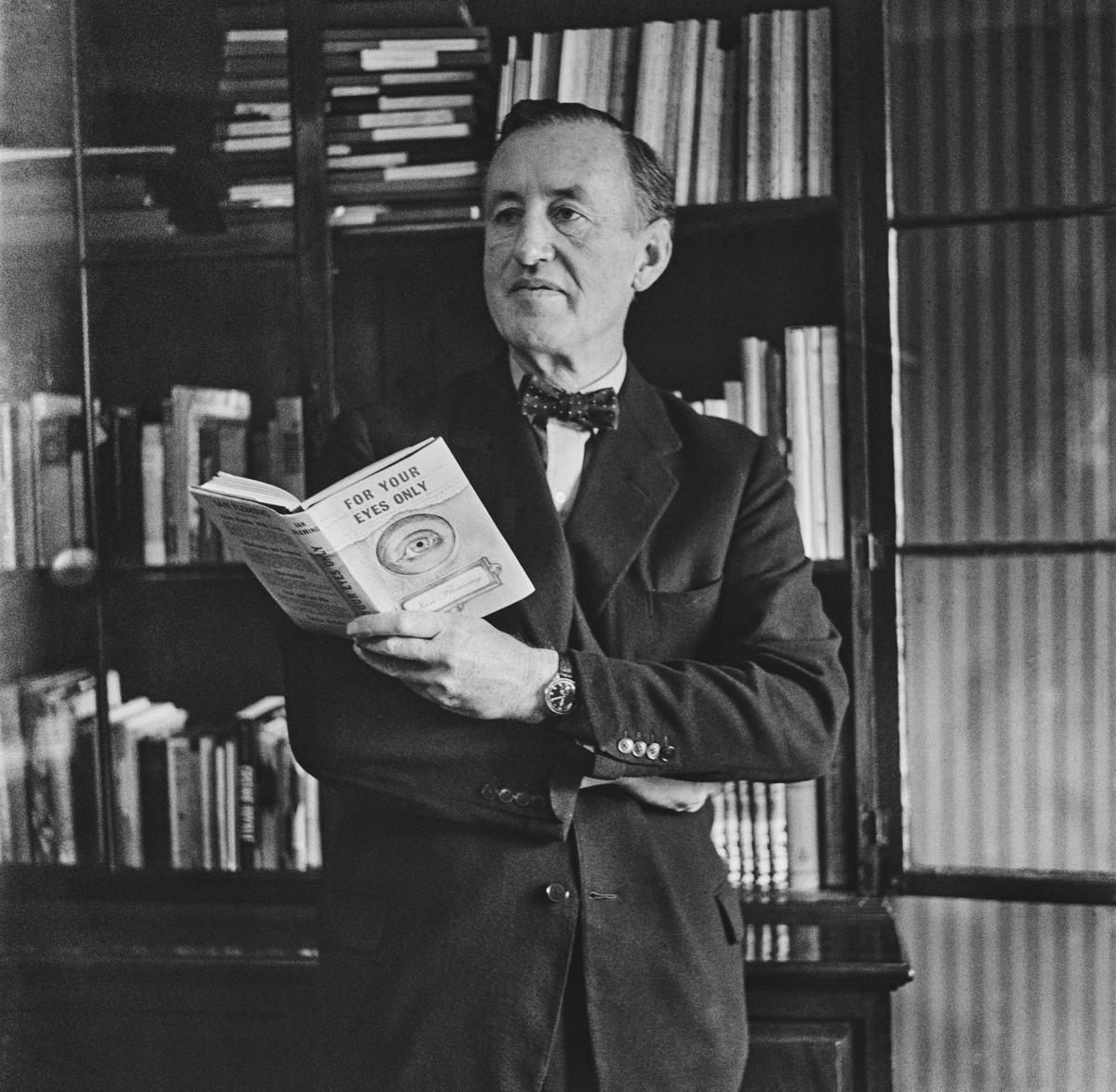 Author Ian Fleming (1908-1964) in his study, holding a copy of For Your Eyes Only, in 1960. 