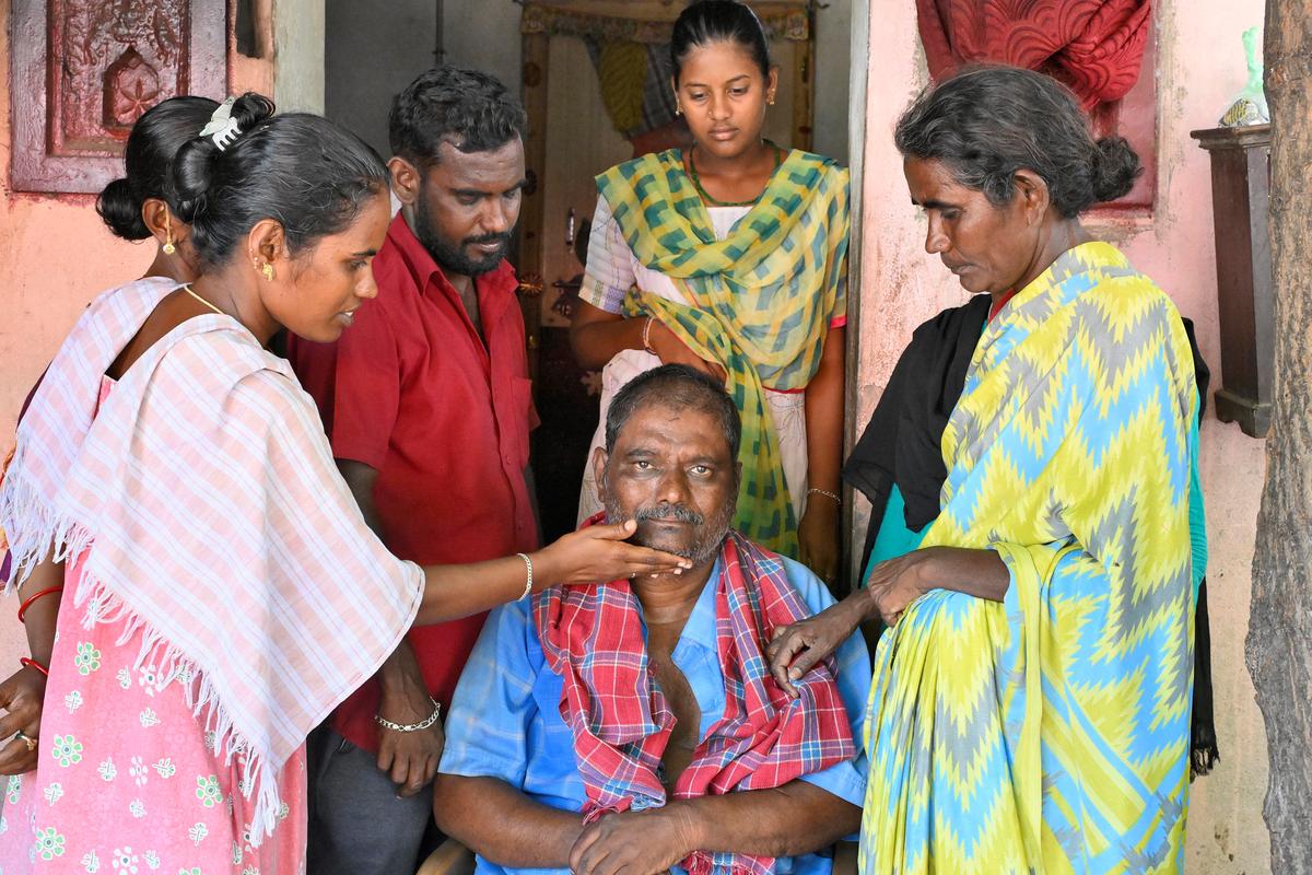 Murugan, a survivor with his family at his house in Karunapuram in Kallakurichi on Monday, June 24, 2024 