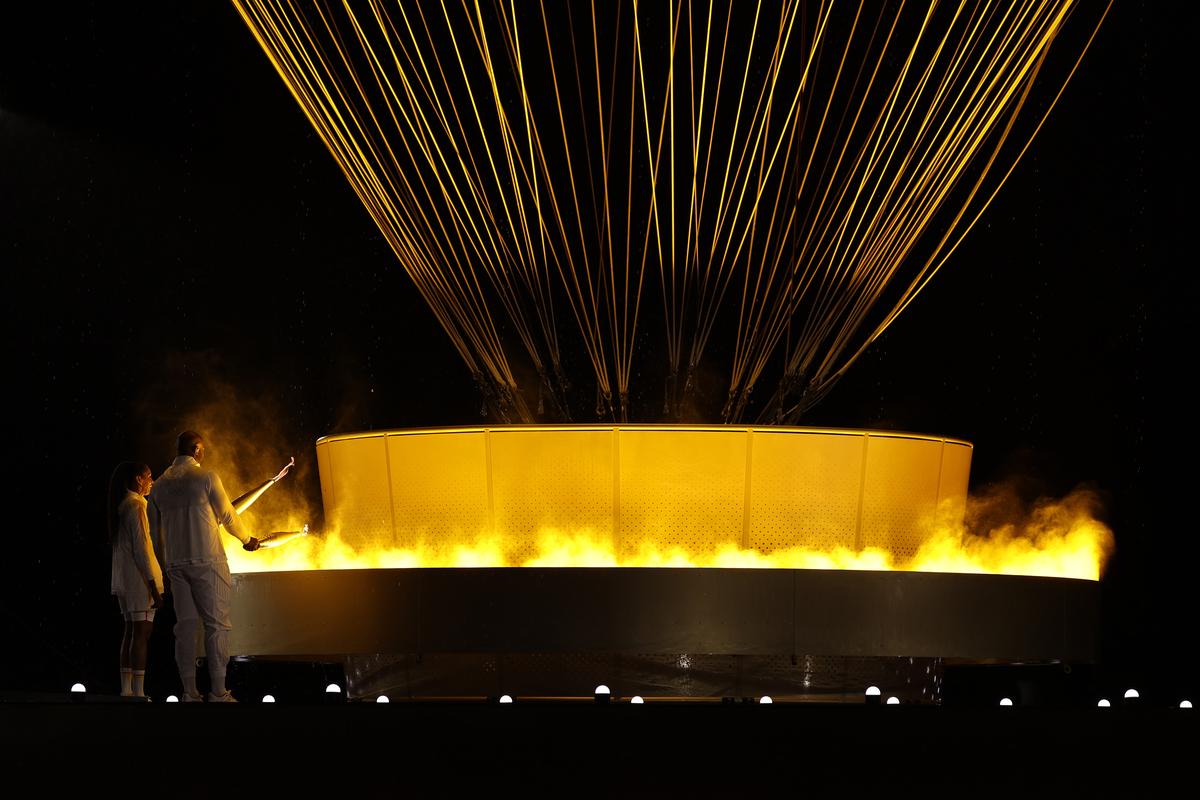 Torch bearers French Athlete Marie-Jose Perec and French Judo Practitioner Teddy Riner light the Olympic Cauldron at the Gardens of the Tuileries during the opening ceremony of the Olympic Games Paris 2024 on July 26, 2024 in Paris, France. 