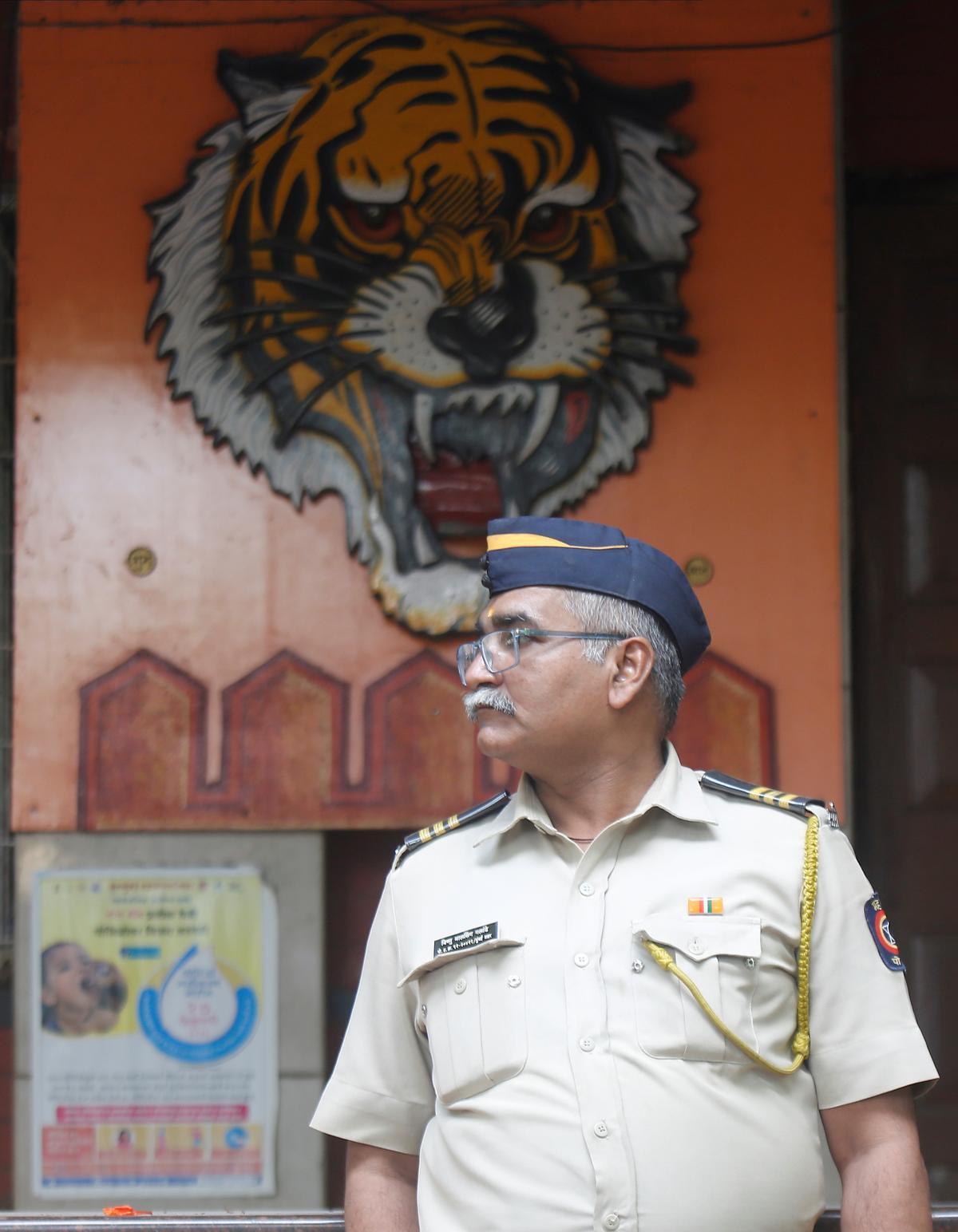 A policeman stands guard outside the Sena’s office in Prabhadevi.