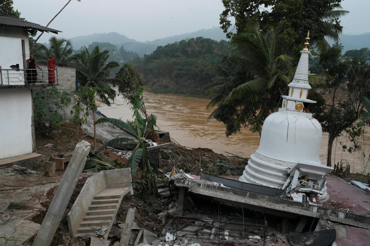 Monks look at a damaged structure of a Buddhist temple after landslides caused by heavy rainfall following Cyclone Ditwah in Kandy, Sri Lanka on December 2, 2025. 