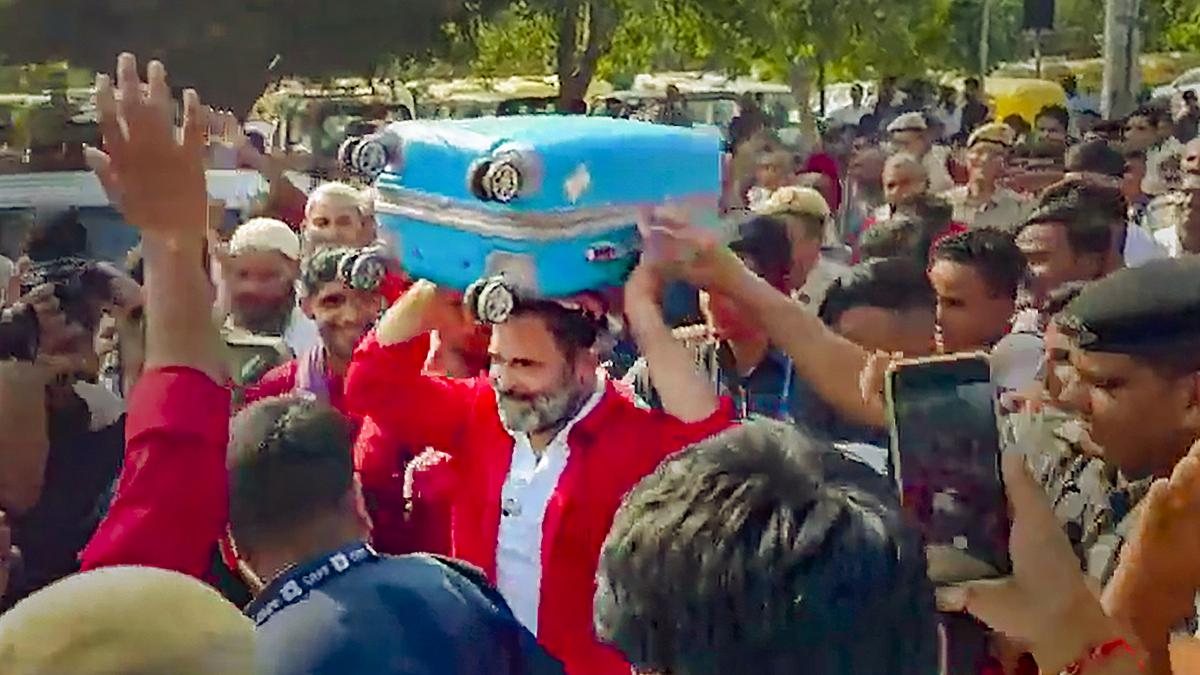 Rahul Gandhi interacts with porters at Anand Vihar railway station