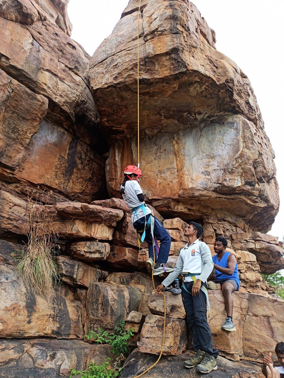 Ishwarya, a student with visual impairment, takes on rock climbing at Gandikota in Kadapa district of Andhra Pradesh.