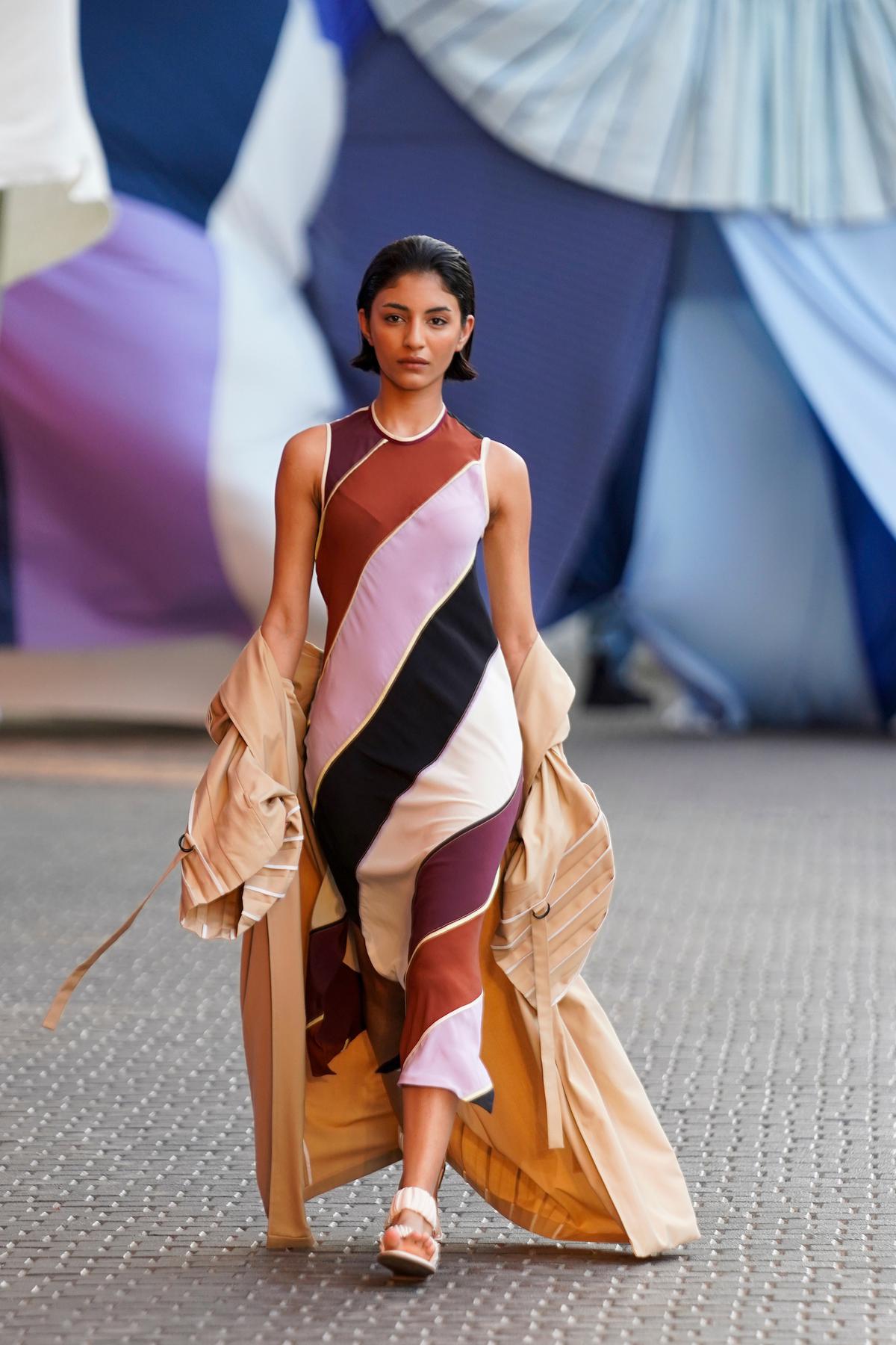 A model walks the ramp during the Bodice show by Rise Worldwide at Lakmé Fashion Week 2023 at Jio gardens in Mumbai. For practical options there were flared trousers and pleated shirt dresses. Separates were an important aspect of the collection, as versatile coordinate sets could be re-worn, styled in numerous ways.