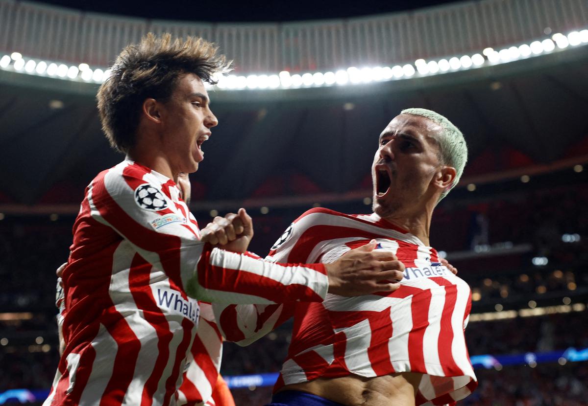 Atletico Madrid’s Antoine Griezmann celebrates with Joao Felix after scoring the team’s second goal against Porto in the UEFA Champions League group stage match