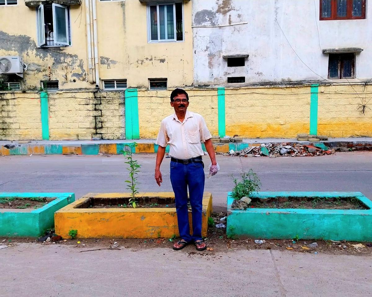 C. Namachivayam, a resident of Indira Nagar, during a planting effort at the divider.  C. Namachivayam, a resident of Indira Nagar, during a planting effort at the divider.