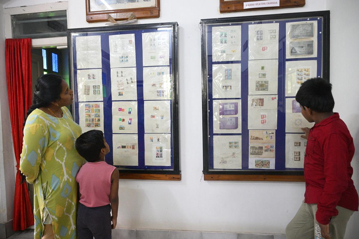आगंतुक हस्तमपट्टी में भारतीय डाकघर भवन, महात्मा गांधी डाक टिकट संग्रह संग्रहालय में प्रदर्शन के लिए रखे गए डाक टिकट संग्रह को देख रहे हैं, जहां महात्मा गांधी 1934 में सेलम की अपनी यात्रा के दौरान रुके थे।