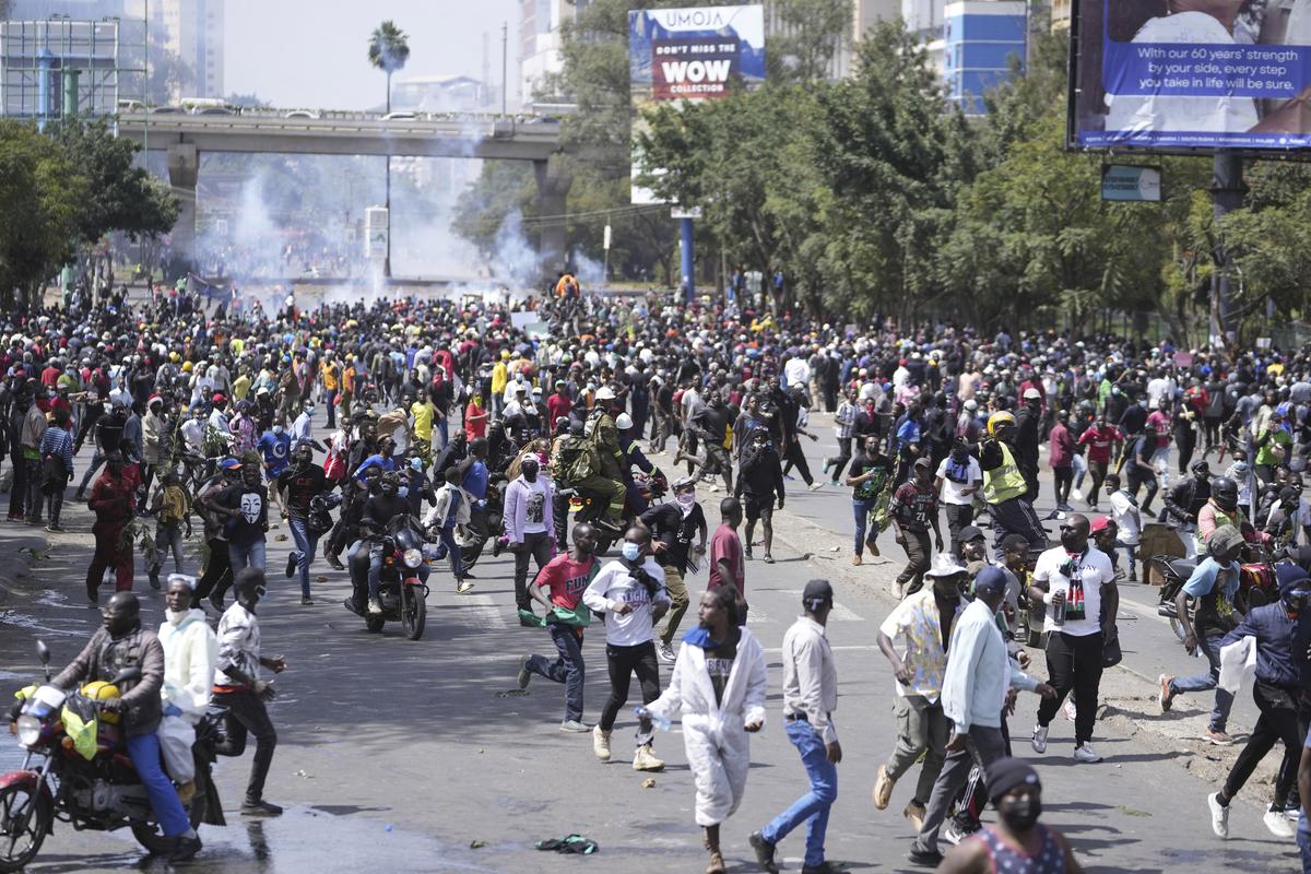 Protesters scatter as Kenya police spray water canon at them during a protest over proposed tax hikes in a finance bill in downtown Nairob on June 25, 2024. Protesters scatter as Kenya police spray water canon at them during a protest over proposed tax hikes in a finance bill in downtown Nairob on June 25, 2024.