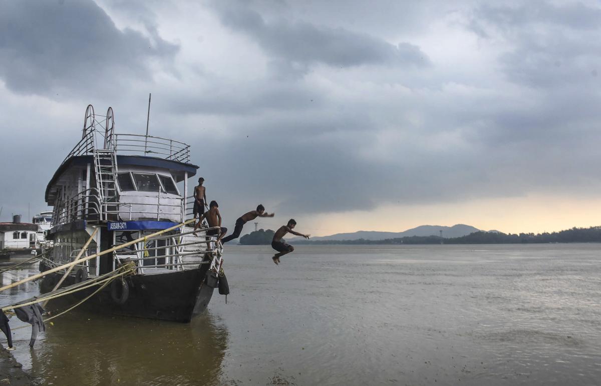 Children jump in the Brahmaputra river in Guwahati.