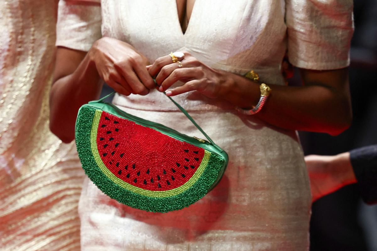 Cast member Kani Kusruti holds a bag depicting a watermelon on the red carpet, during arrivals for the screening of the film 'All We Imagine as Light' in competition at the 77th Cannes Film Festival in Cannes, France, May 23, 2024. REUTERS/Sarah Meyssonnier