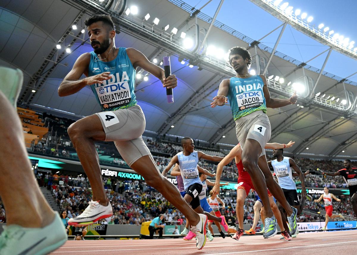 Amoj Jacob hands the baton to Muhammed Ajmal Variyathodi .