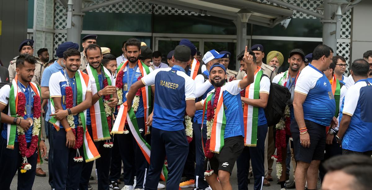 The Indian men’s hockey team players celebrate after their arrival at Delhi airport after winning a bronze medal at the Paris Olympics 2024 on Saturday.