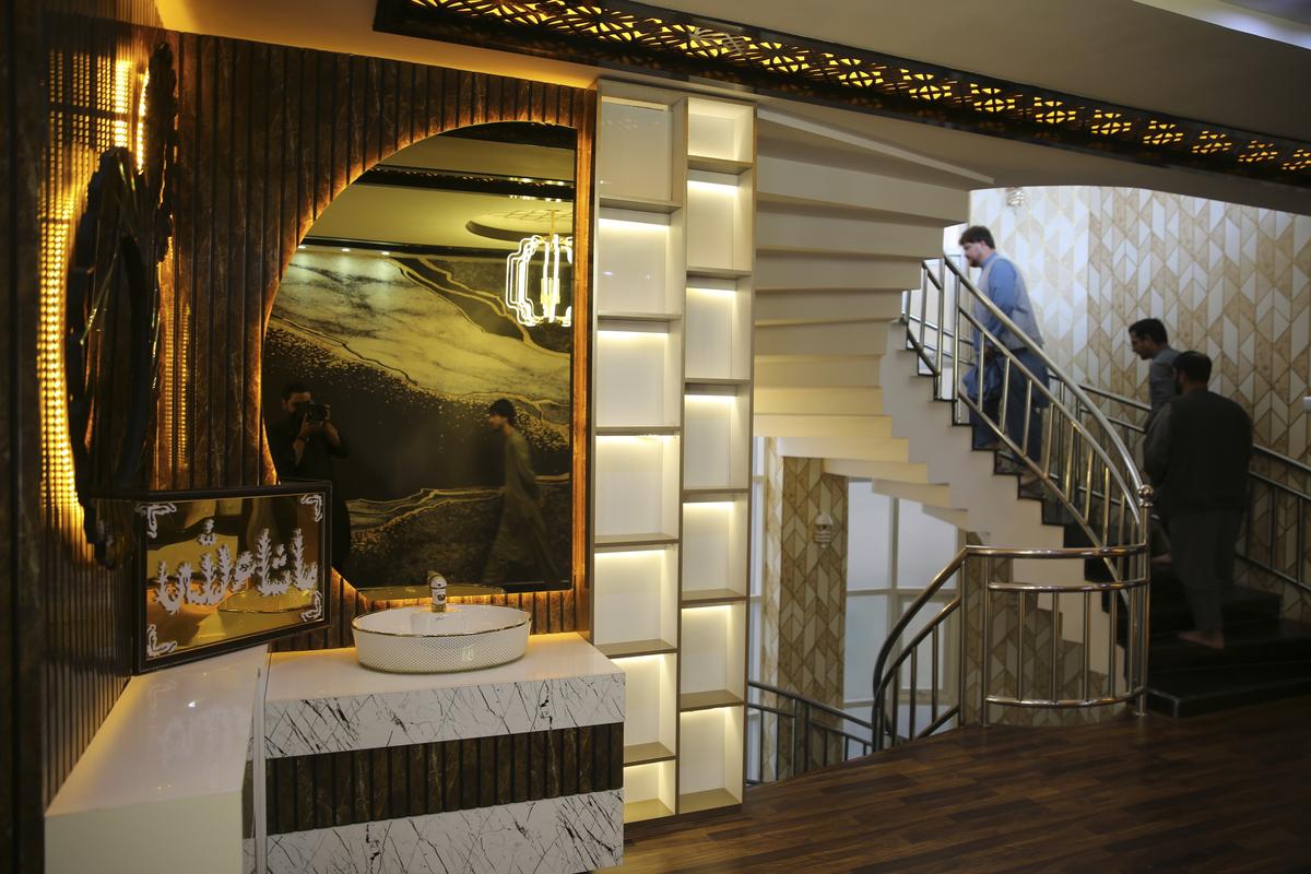 Men walk through a luxury house in the city of Kabul, Afghanistan, Sept. 23, 2024. 