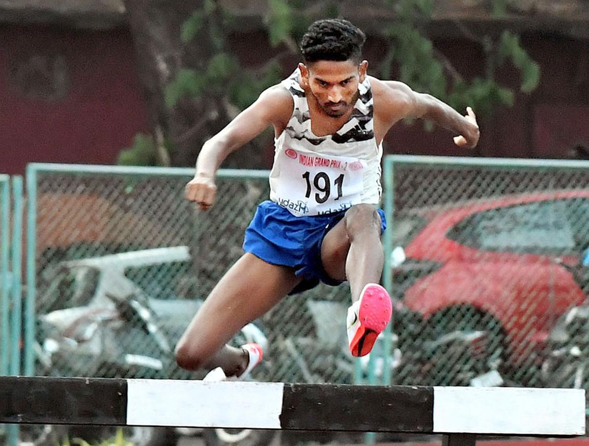 Avinash Sable crosses the last hurdle to  set a new National record in the men’s 3000m steeple chase event of the second leg of the India Grand Prix in Thiruvananthapuuram on 23/03/2022.