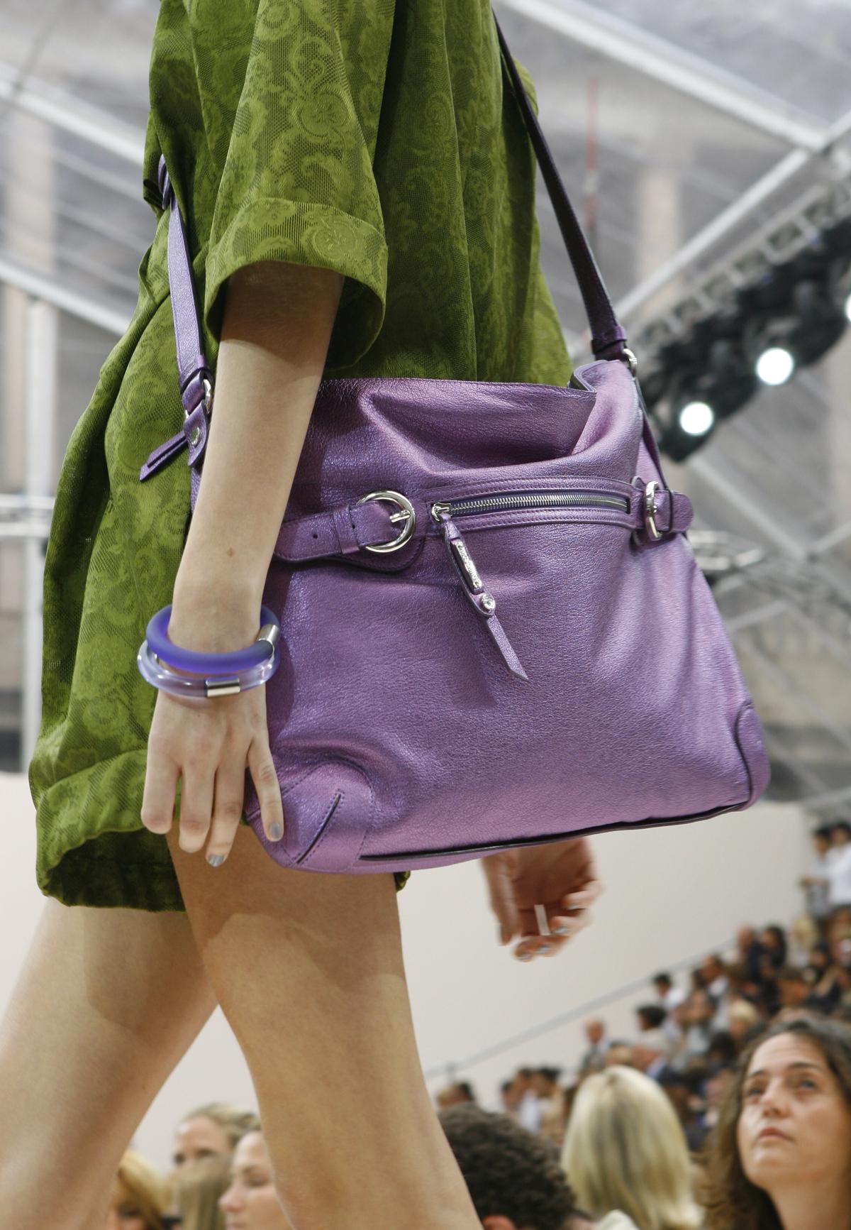 A model sports a purple handbag as part of the Moschino Spring/Summer 2008 collection presented in Milan, Italy on Sept, 25, 2007.