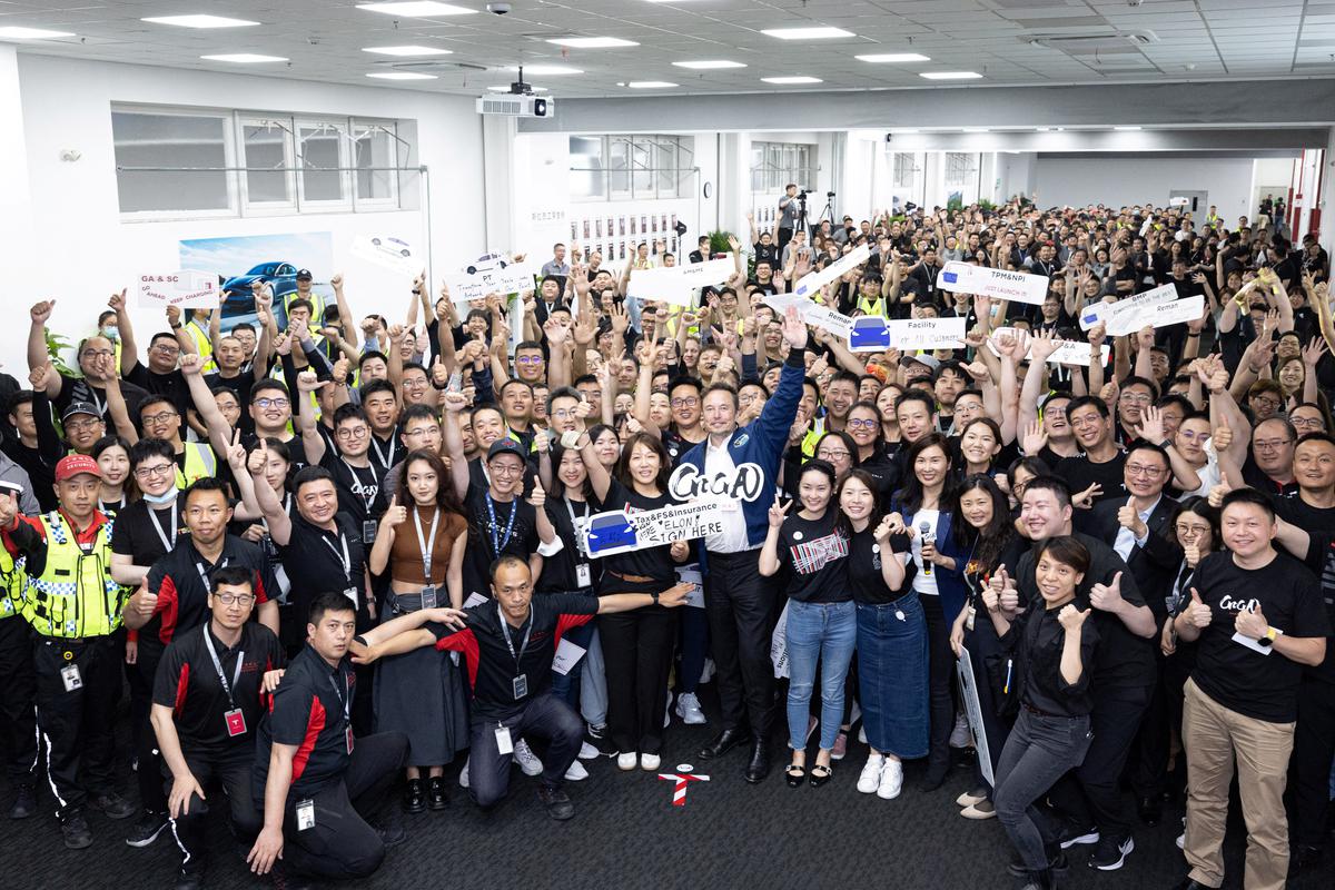 Tesla Chief Executive Officer Elon Musk poses for a group photo at the Shanghai Gigafactory of the U.S. electric vehicle maker in Shanghai, China, in this handout image released on June 1, 2023. Tesla/Handout via Reuters 