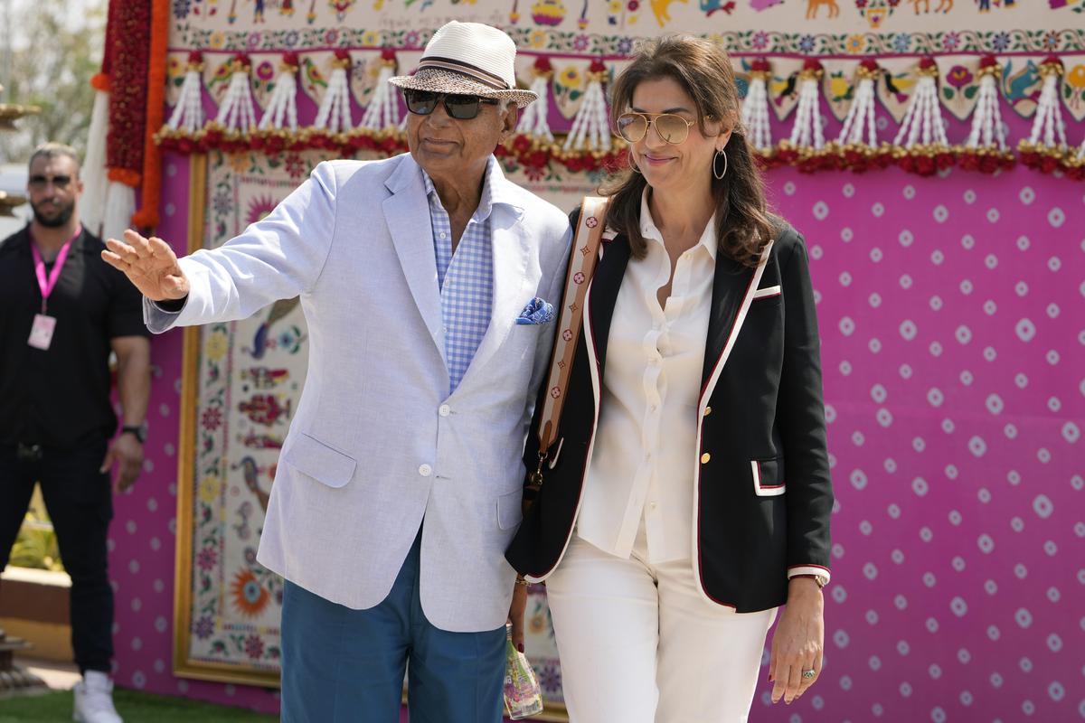 Chairman of DLF, K P Singh, left, poses for a  photograph as he arrives to attend a pre-wedding bash of billionaire industrialist Mukesh Ambani’s son Anant Ambani, in Jamnagar