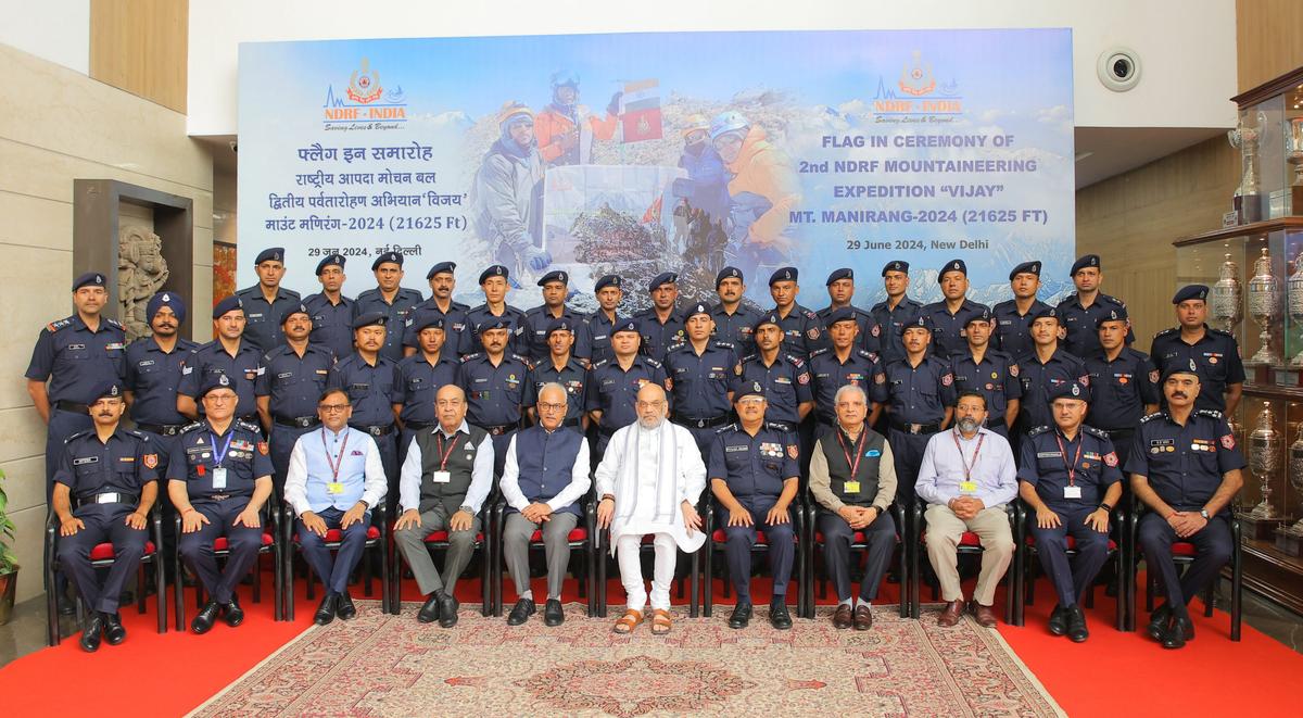 Union Home Minister Amit Shah poses for group photograph during the flag-in ceremony of mountaineering expedition Vijay, accomplished by the NDRF, in New Delhi, on June 29, 2024.