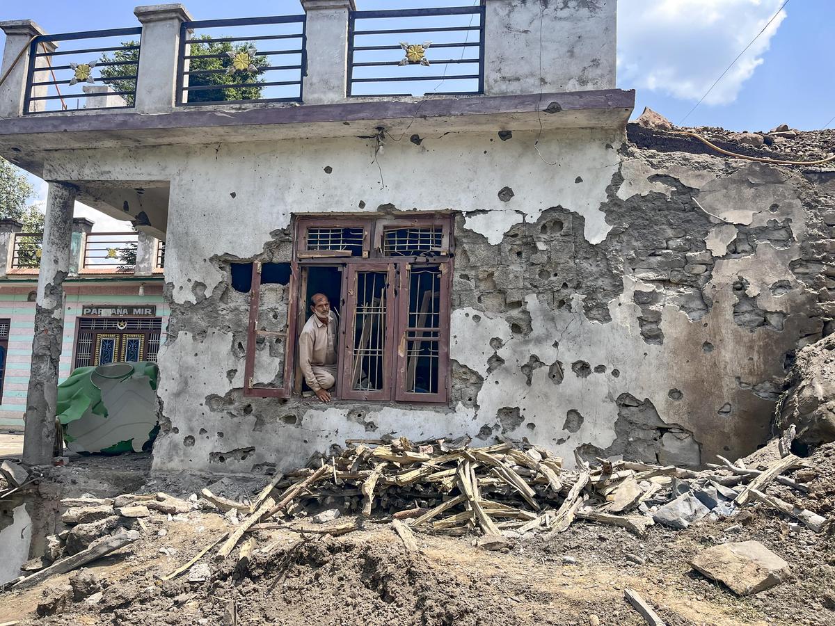 A man stands inside a house damaged after cross border shelling by Pakistan at Behra village of Mendhar sector, in Poonch district, Jammu and Kashmir on May 10, 2025. 
