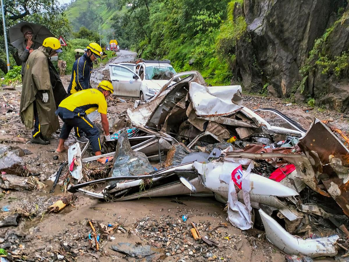 State Disaster Response Force (SDRF) personnel during a rescue and relief operation after vehicles were hit by falling debris after rain-triggered landslide on Uttarkashi-Gangotri highway, in Uttarkashi district, Tuesday, July 11, 2023. 
