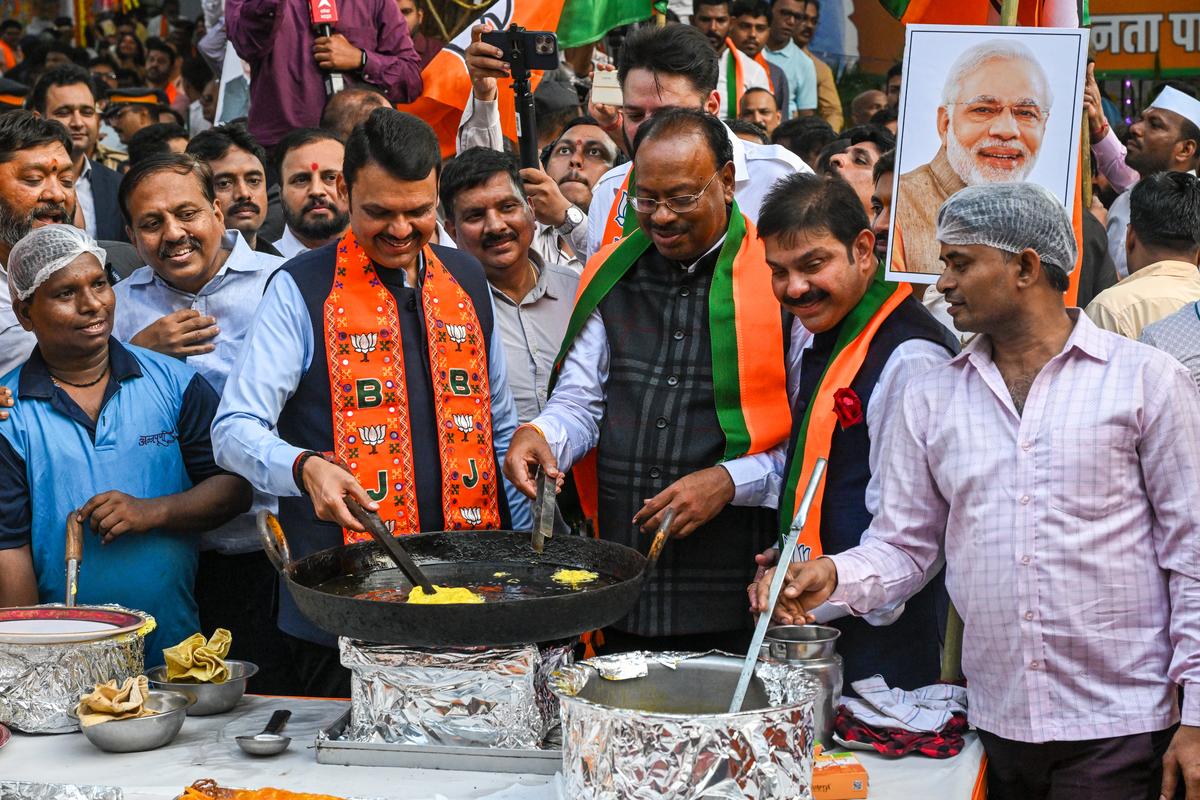 Maharashtra CM Devendra Fadnavis with State BJP president Chandrashekhar Bawankule make jalebis during their Assembly poll victory celebrations outside the party headquarters.