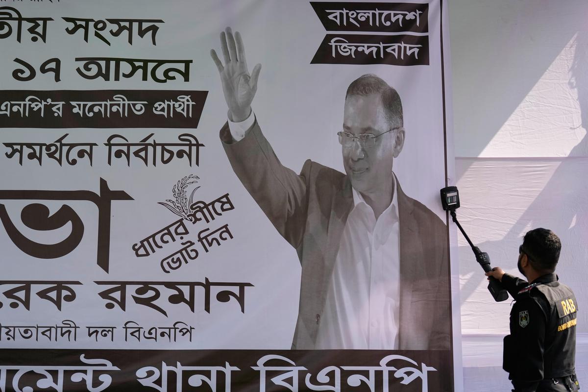 Security personnel check a banner with a metal detector before the start of an election rally of Tarique Rahman, the son of former Prime Minister Khaleda Zia and chairman of the Bangladesh Nationalist Party (BNP), ahead of national election, on a road in Dhaka, Bangladesh, Sunday, Feb. 8, 2026. (AP Photo/Anupam Nath)