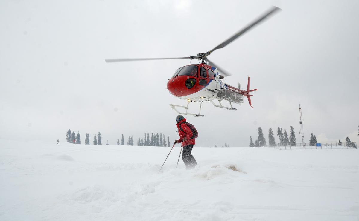 The skiers stand on top of a snow covered mount before boarding the helicopter after the three-day long Airbus International Heli-Ski competition, organized by Airbus Helicopters in collaboration with Kashmir Heli-Ski, was kicked off at the world famous ski resort Gulmarg at Kongdoori , 60km (37 miles) from  Srinagar on February 21, 2014. 
Photo: Nissar Ahmad