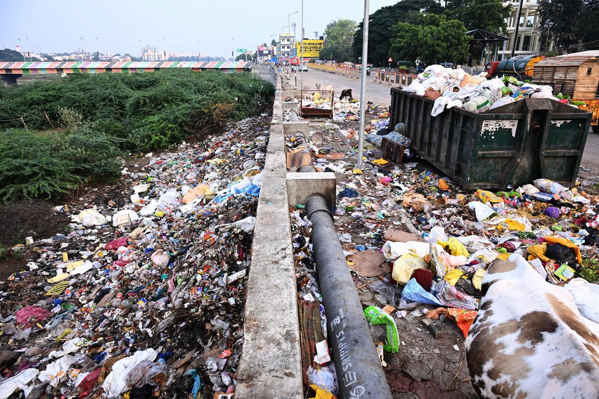 Waste overflows into Vaigai river from the dust bin kept on North Bank Road near Kuruvikaran Salai bridge in Madurai. Waste overflows into Vaigai river from the dust bin kept on North Bank Road near Kuruvikaran Salai bridge in Madurai.