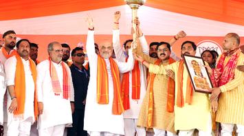  Union Home Minister Amit Shah holds a mace with Bharatiya Janata Party (BJP) candidate from Ambedkar Nagar seat Ritesh Pandey during a public meeting for the sixth phase of the Lok Sabha elections, in Ambedkar Nagar on Thursday.  