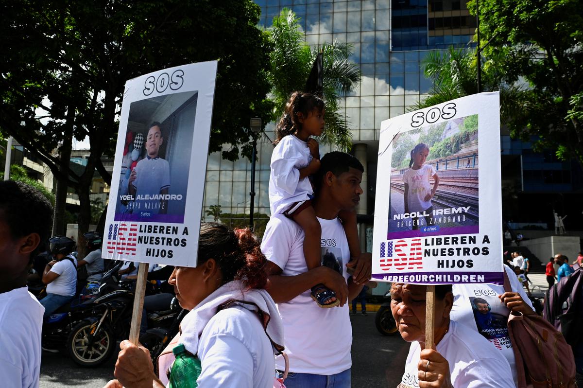 Demonstrators hold signs reading “SOS, USA FREE OUR CHILDREN” and with pictures of Venezuelan migrant children remaining in the U.S. after they were separated from their parents who were deported, during a march demanding their return, in Caracas, Venezuela July 10, 2025. 
