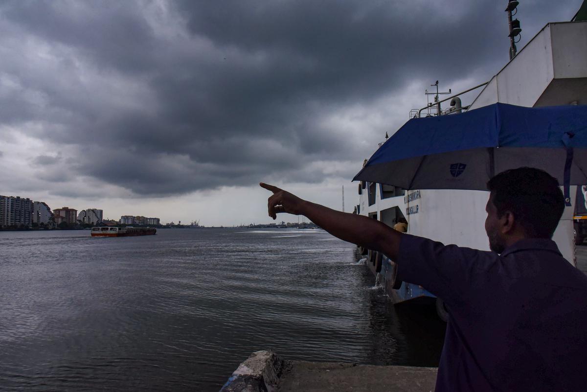 A man points at dark clouds covering Kochi’s skyline, Friday, May 26, 2023 A man points at dark clouds covering Kochi’s skyline, Friday, May 26, 2023