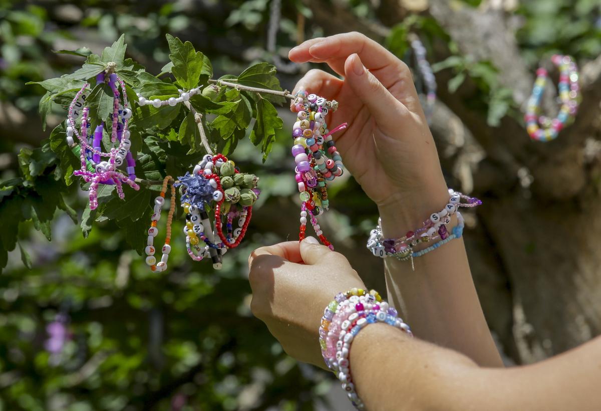 Swifties fix bracelets on a tree in the city centre in Vienna on Thursday, Aug.8, 2024. Organizers of three Taylor Swift concerts in the stadium in Vienna this week called them off on Wednesday after officials announced arrests over an apparent plot to launch an attack on an event in the Vienna area such as the concerts