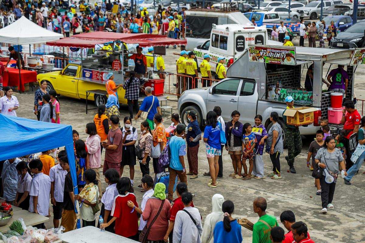 People wait in line to get food at a shelter, following recent clashes along the disputed border between the two countries, according to authorities people have been killed across three border provinces, in Buriram province, Thailand, July 24, 2025.