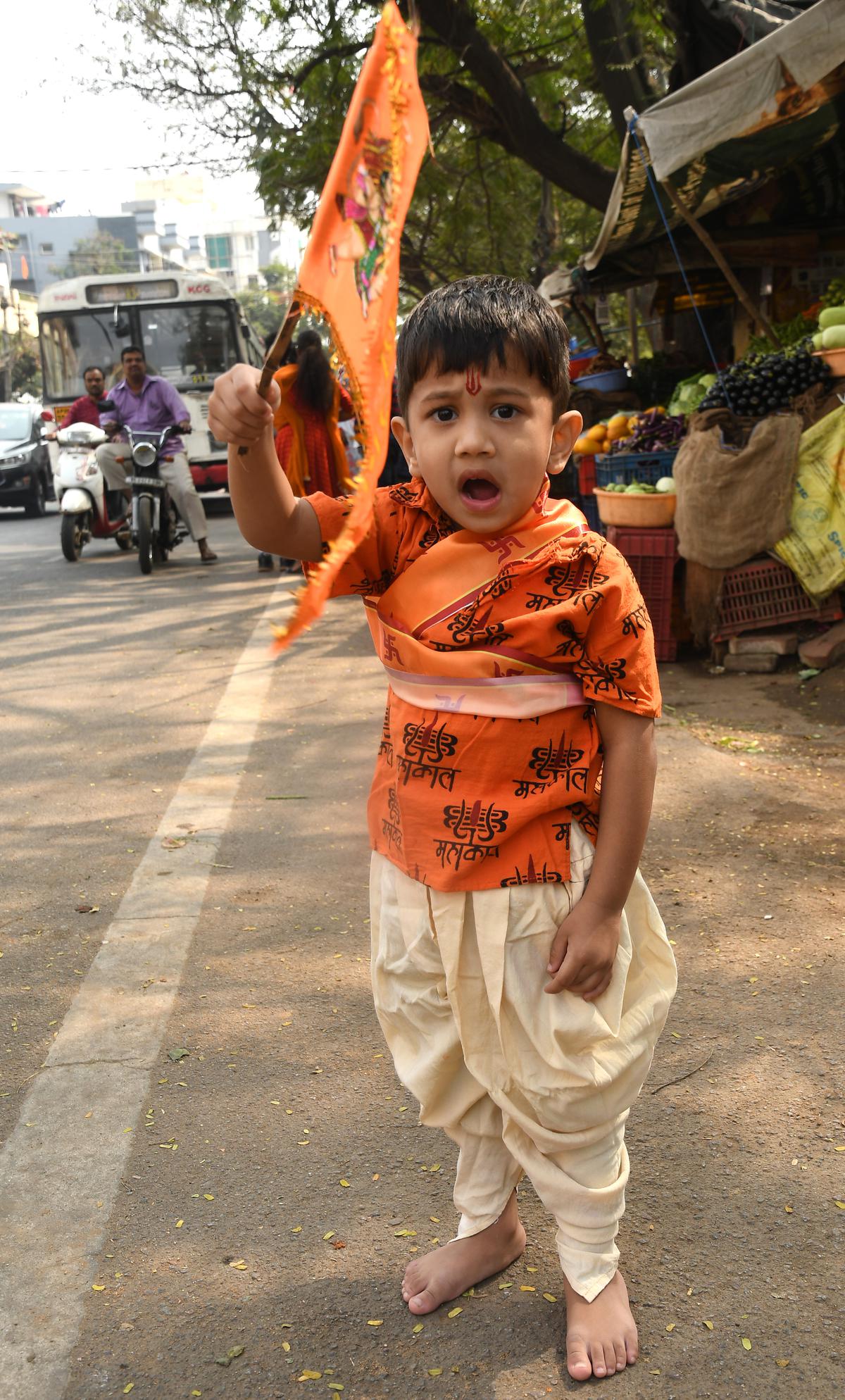 A child participating a procession on the occasion of Ram Lalla Pran Pratishtha ceremony in Ayodhya, in Hyderabad. 