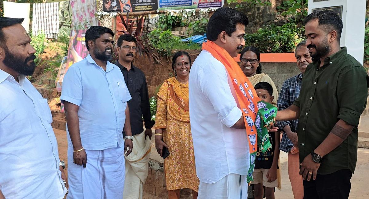 K.K. Aneesh Kumar, the BJP candidate, interacting with people during his campaign in Manalur.