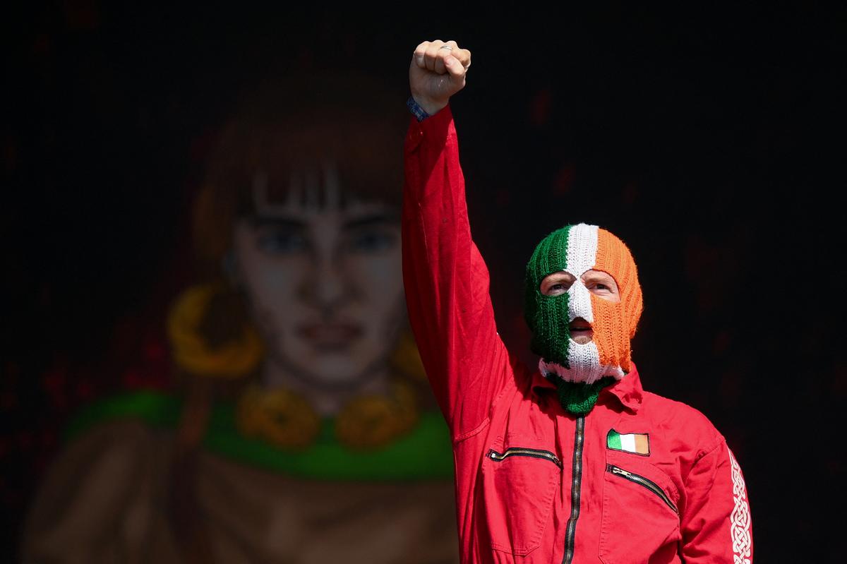 DJ Provai of Kneecap, wearing a balaclava in the colours of the Irish flag, performs at Glastonbury Festival at Worthy Farm in Pilton, Somerset, Britain, June 28, 2025. 