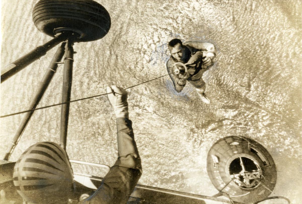 Alan Shepard is picked up by a helicopter within seconds of the space capsule landing in the water. 