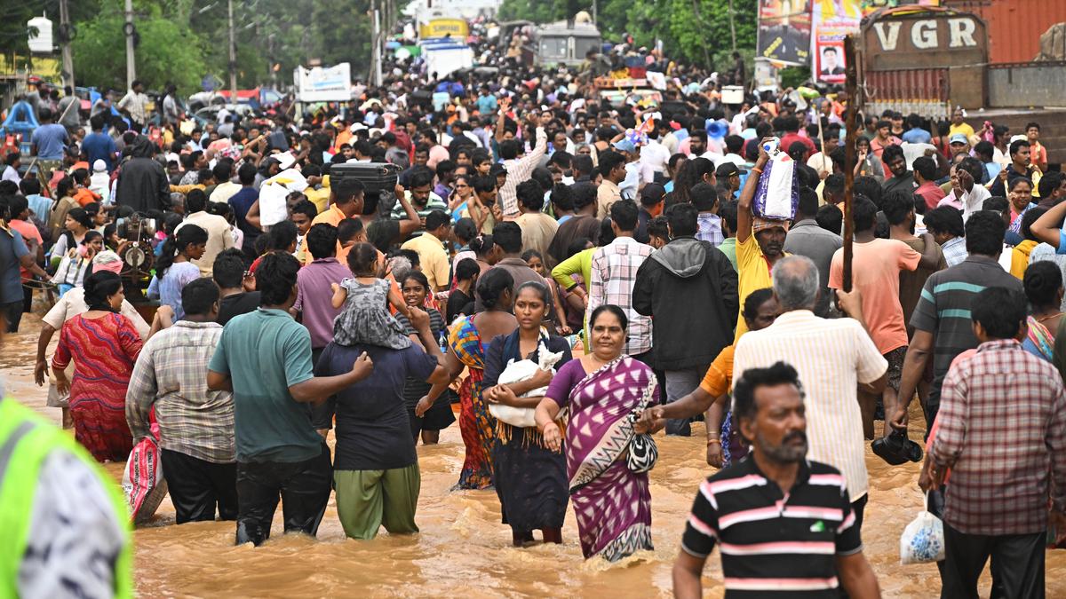 With water receding a bit, thousands from flood-hit areas in Vijayawada step onto the road to safety