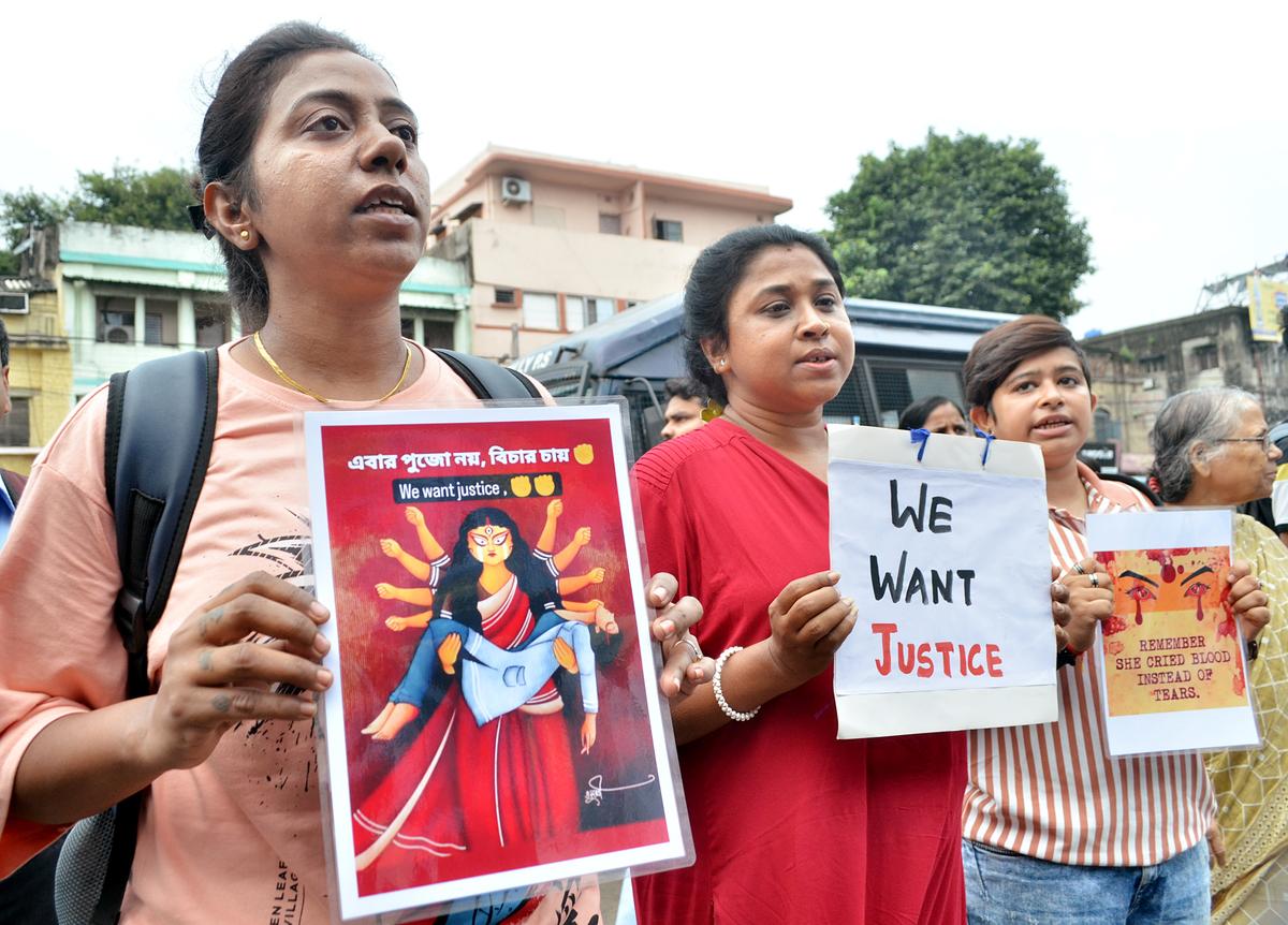 Medical staff and others hold posters during a protest march from NRS Hospital to Rajbhavan against the West Bengal government over Kolkata’s R.G. Kar Medical College rape-murder case, in Kolkata on September 7, 2024