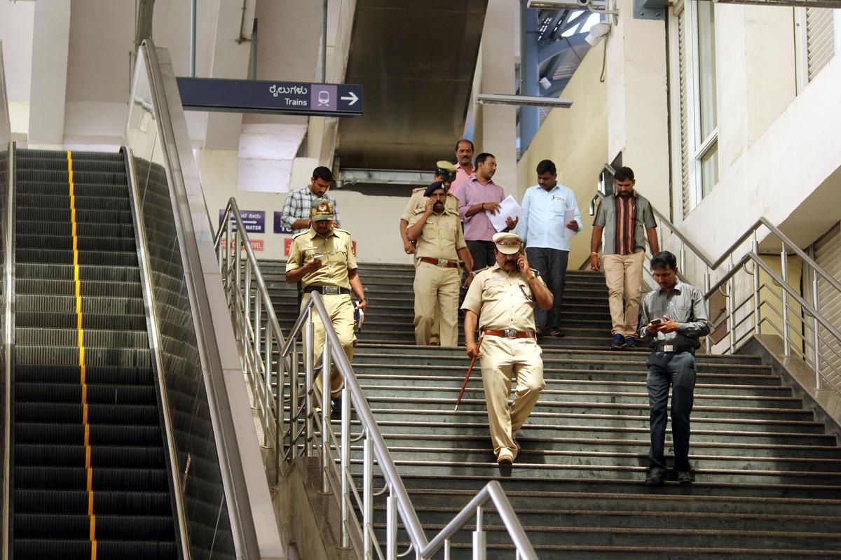 Police officials and bomb detection squad at the Namma Metro Magadi Road Station after a bomb threat which turned out to be a hoax.
