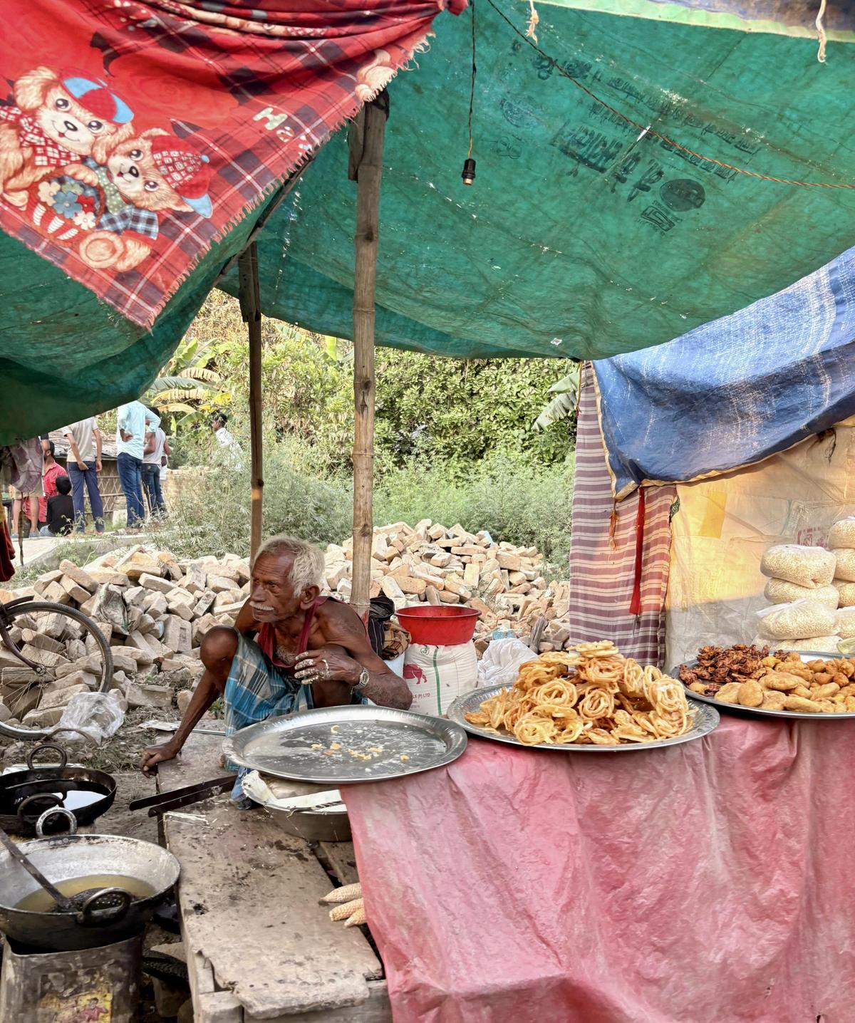 Suresh Paswan, an ex-mill worker, selling snacks in his roadside shop.