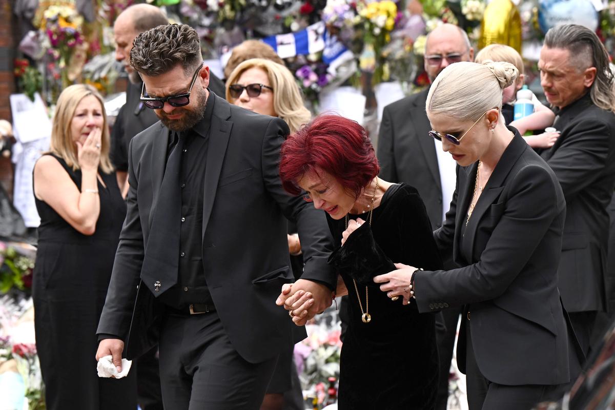 (L-R) Jack Osbourne, Sharon Osbourne and Kelly Osbourne arrive to view tributes to the late Ozzy Osbourne from fans as his funeral cortege travels through his home city of Birmingham on July 30, 2025, in Birmingham, England. (L-R) Jack Osbourne, Sharon Osbourne and Kelly Osbourne arrive to view tributes to the late Ozzy Osbourne from fans as his funeral cortege travels through his home city of Birmingham on July 30, 2025, in Birmingham, England.